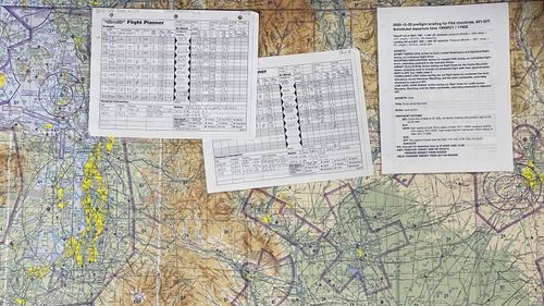 An aviation chart and navigation paperwork