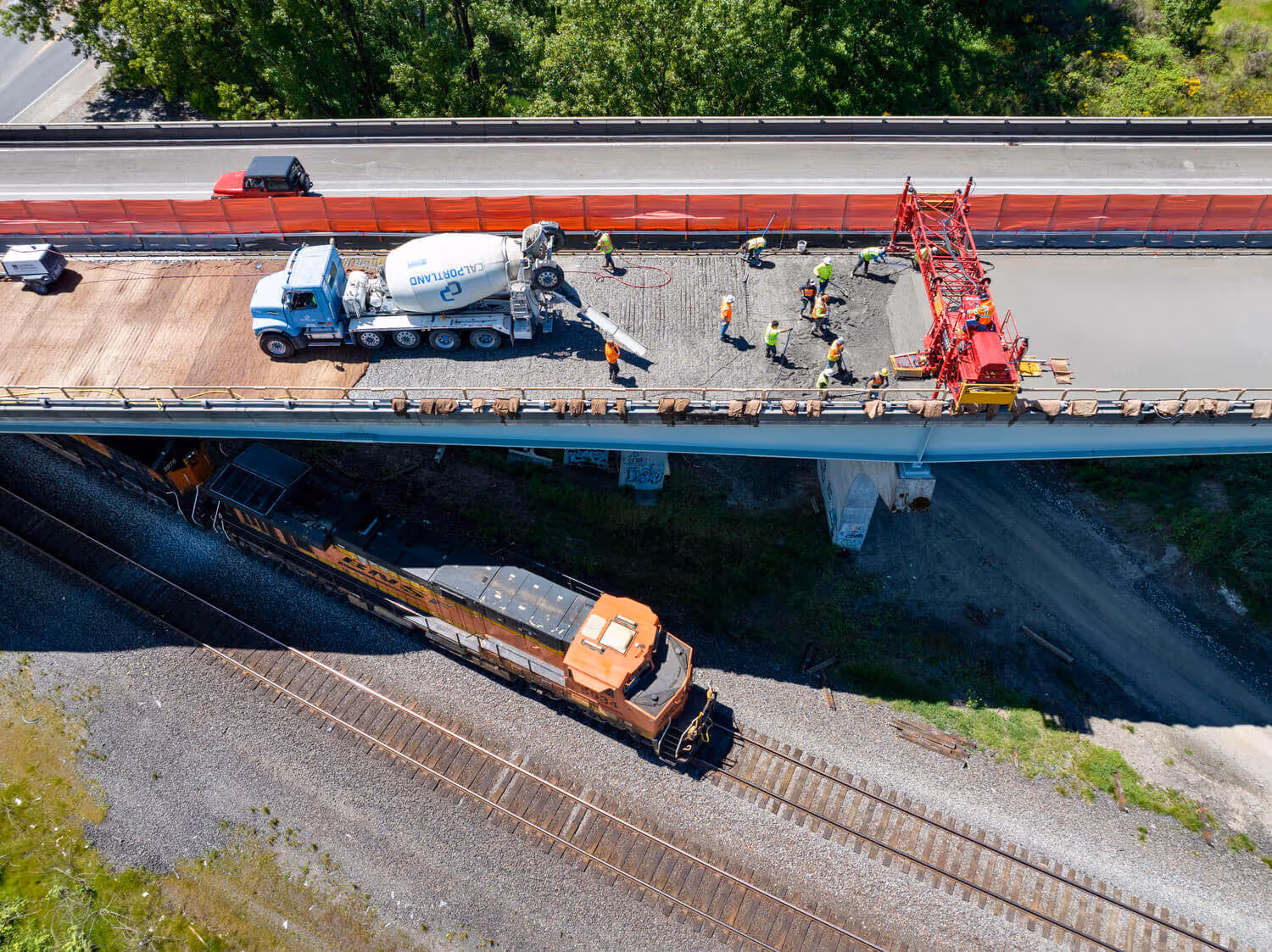A train passes beneath a bridge under construction on Interstate 5 in Woodland, Washington