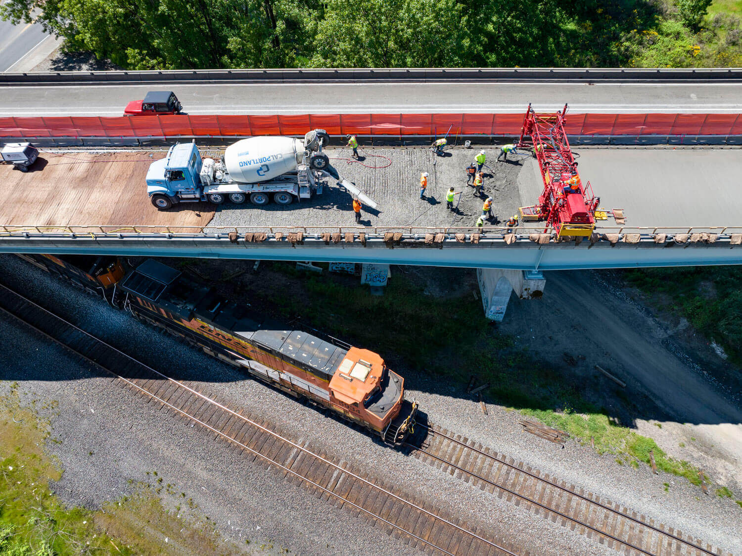 A train passes beneath a bridge under construction on Interstate 5 in Woodland, Washington