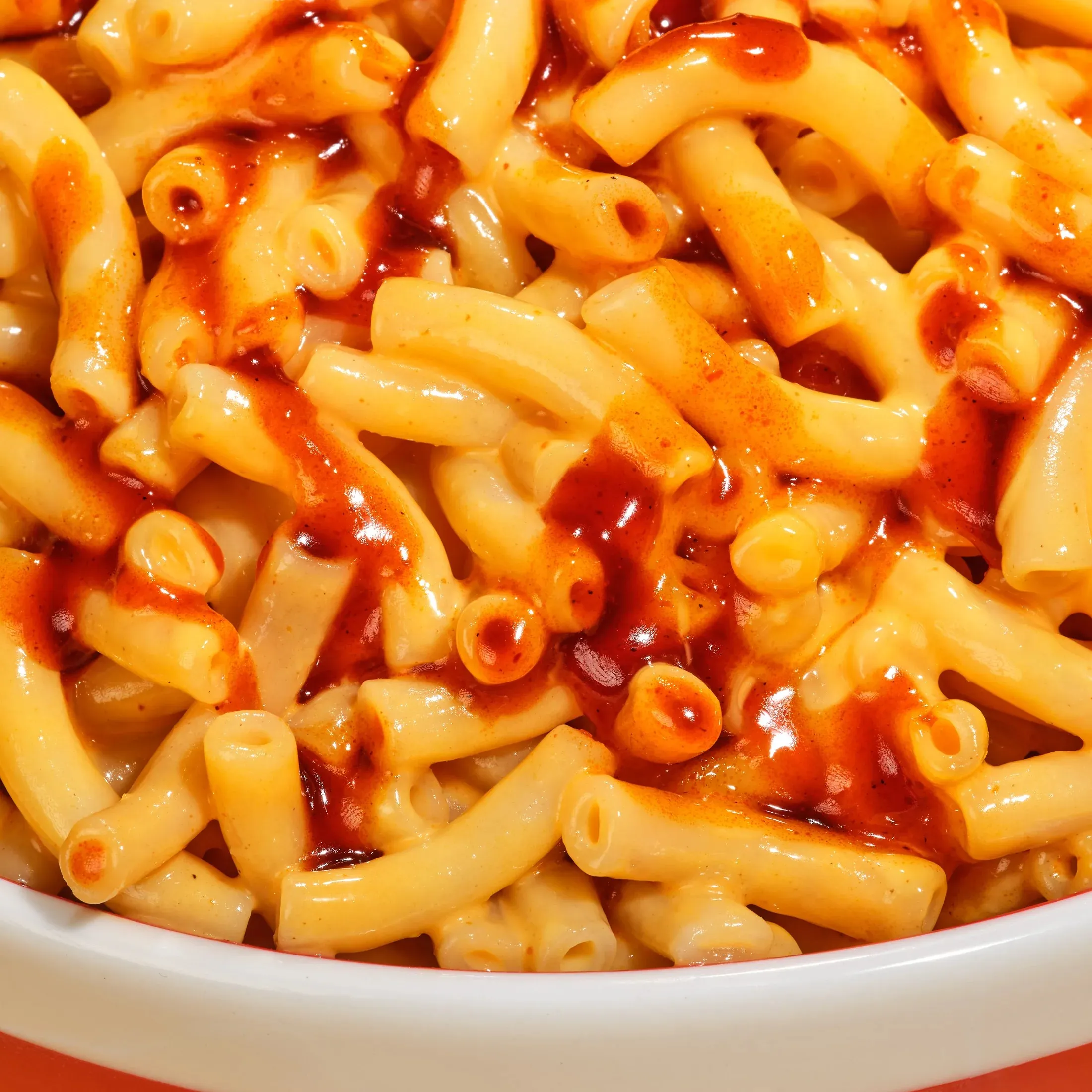 Close up of sweet corn pasta with chilli sauce in a white bowl