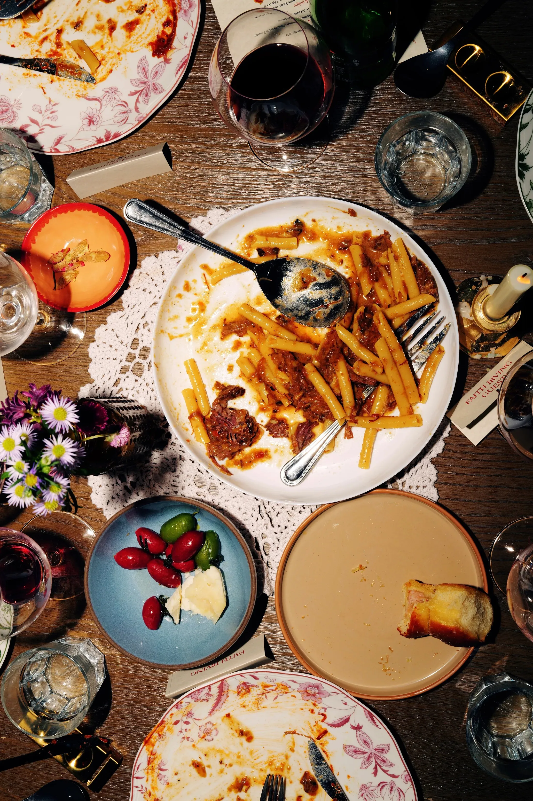 Overhead table spread of pasta and wine at Lele Dinner Club