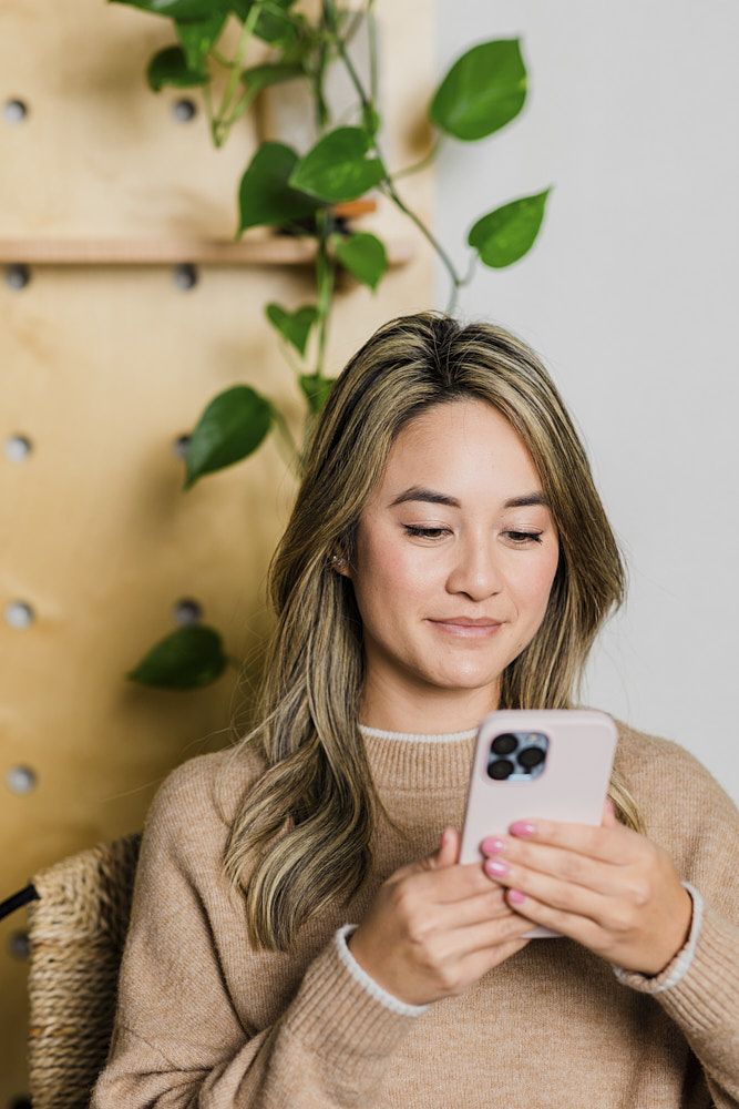 Photo of a woman searching for candidates on her phone
