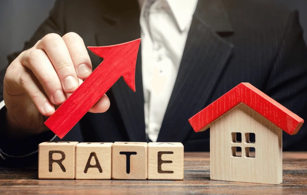 man-holds-red-arrow-above-cap-rate