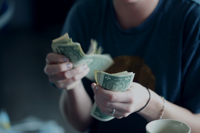 Girl counting money as fundamentals for cash flow