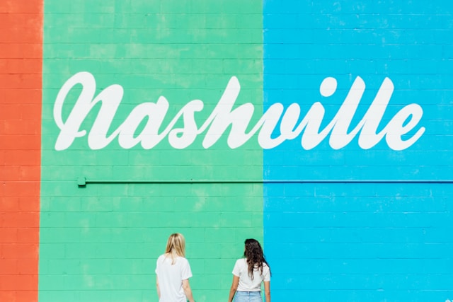 Two women facing wall with Nashville text