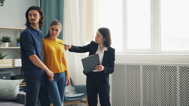 Real estate agent and couple in a rental home