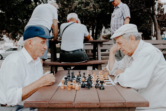 Two old men playing chess in senior housing facility