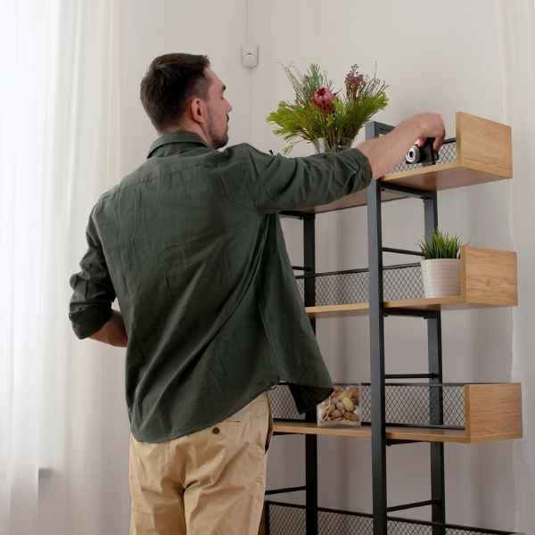 Man Arranging Decor On Shelf Stock Video