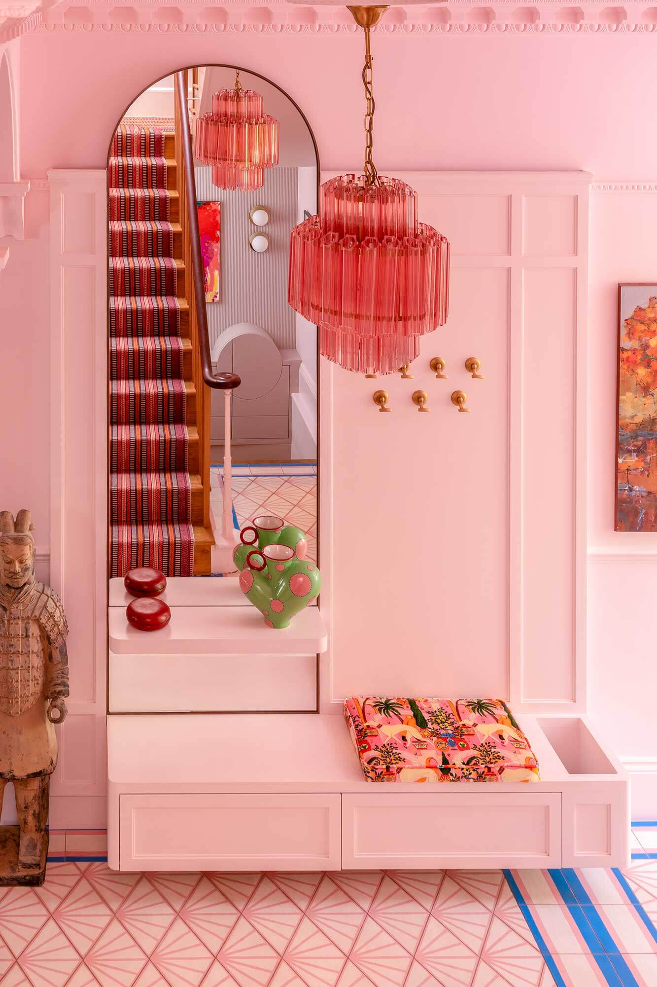 Pink hallway with bespoke pink and blue floor tiles, and bespoke joinery piece