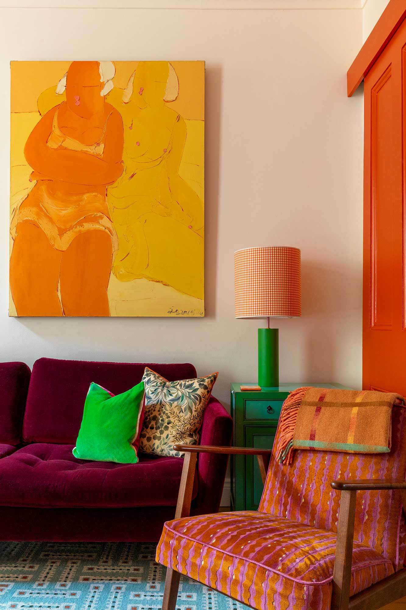 Vibrant colours and reupholstered armchair in living room