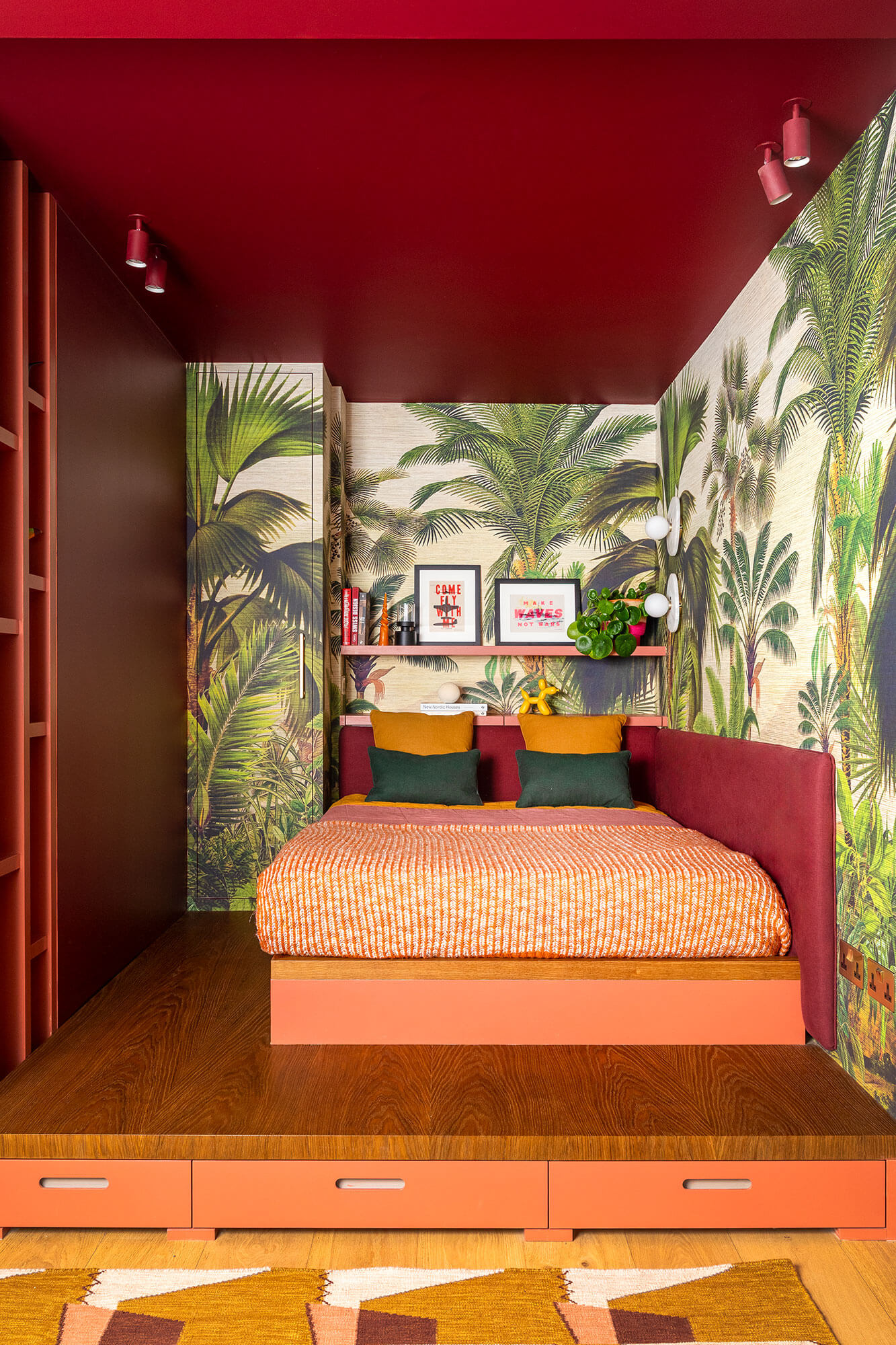 platform bed with drawers and a padded headboard that wraps the corner