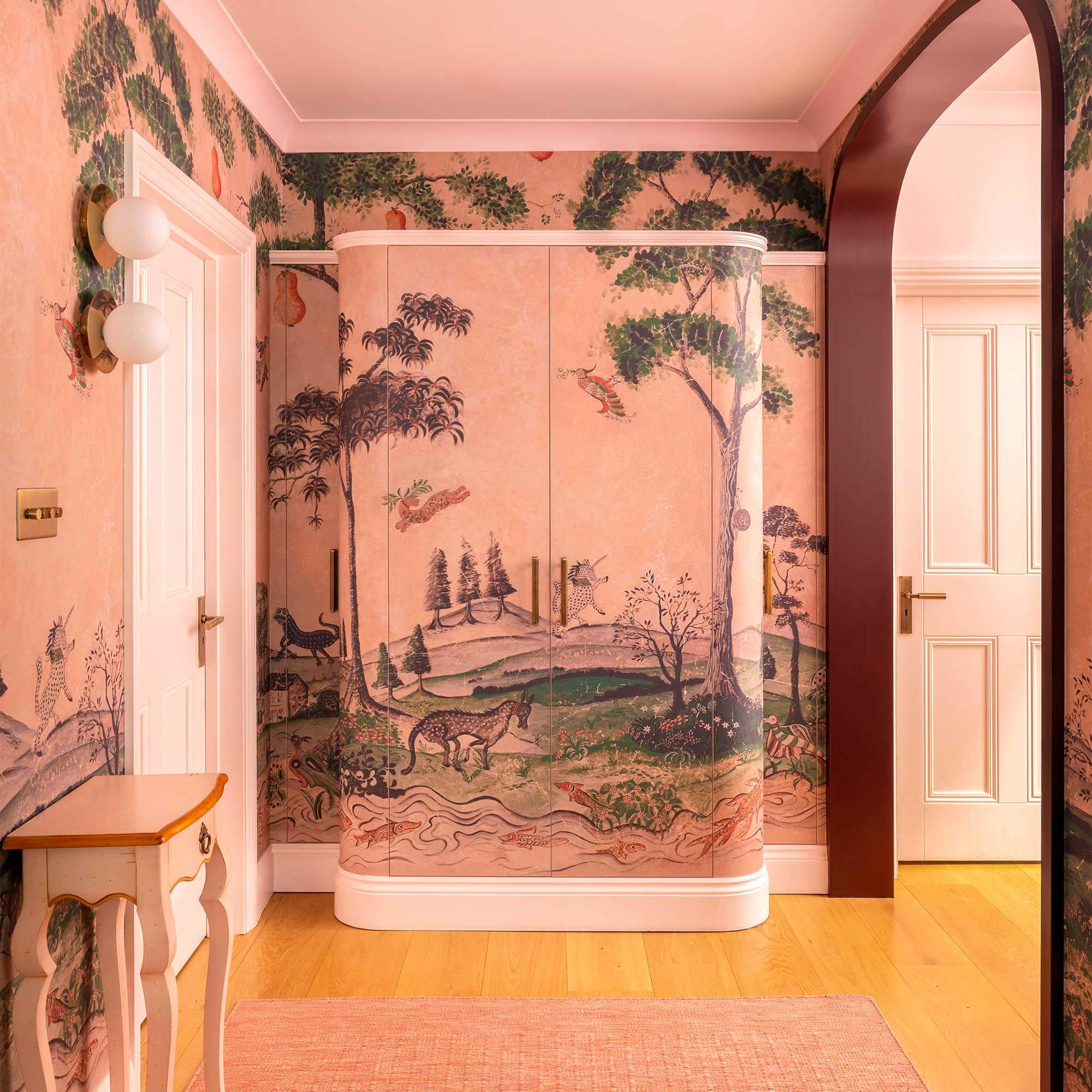 Linen cupboard clad in Andrew Martin wallpaper