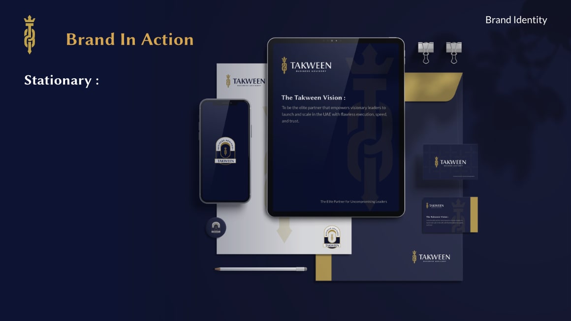 Takween branded stationery set including an iPad displaying the company vision, smartphone, envelope, business cards, button pins, pencil, and paper clips on a dark background.