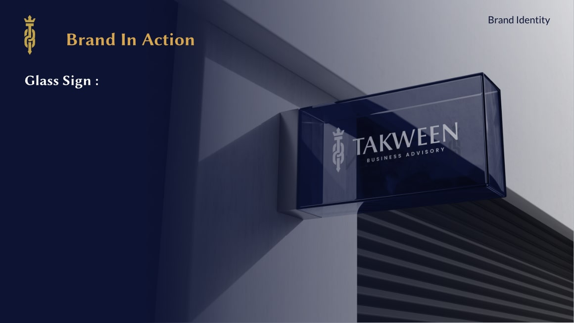 Glass sign mounted on a building corner displaying the TAKWEEN Business Advisory logo and name.