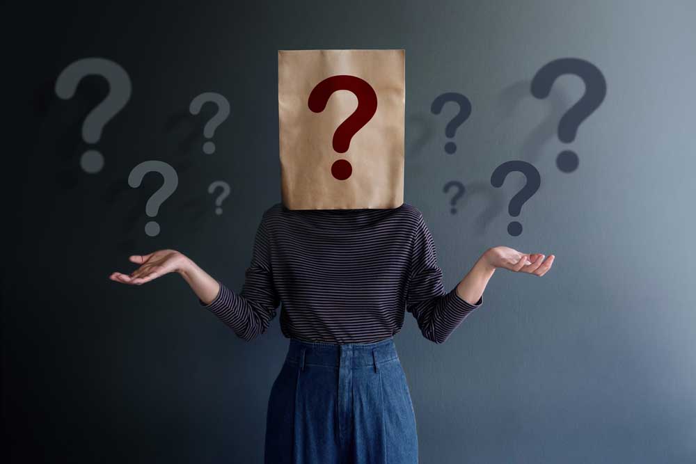 Who? Image of a person with a question mark covering his or her face. 