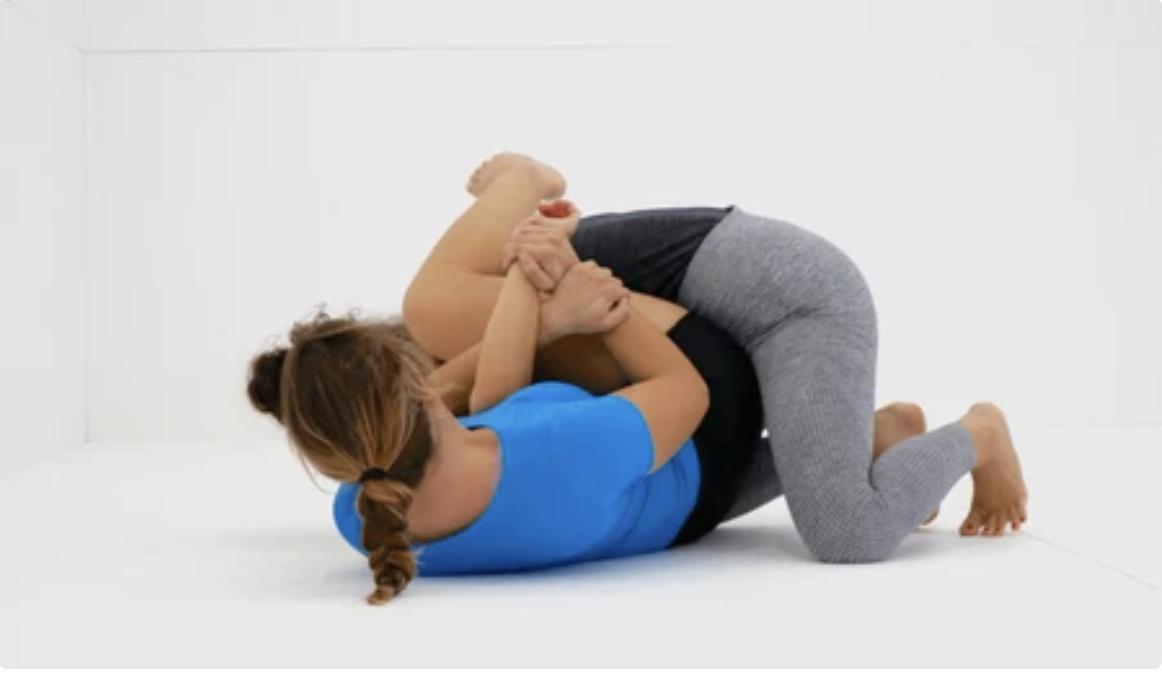 Instructor tying belt of a child student