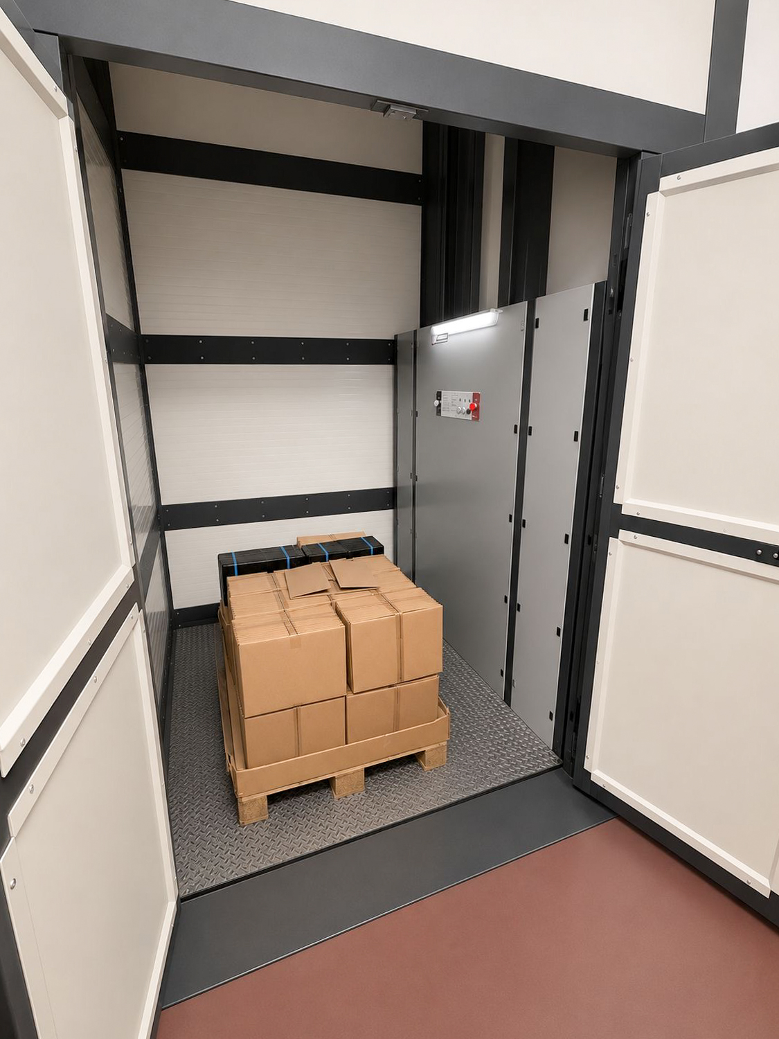 Industrial goods lift with pallet loaded with stacked cardboard boxes inside.