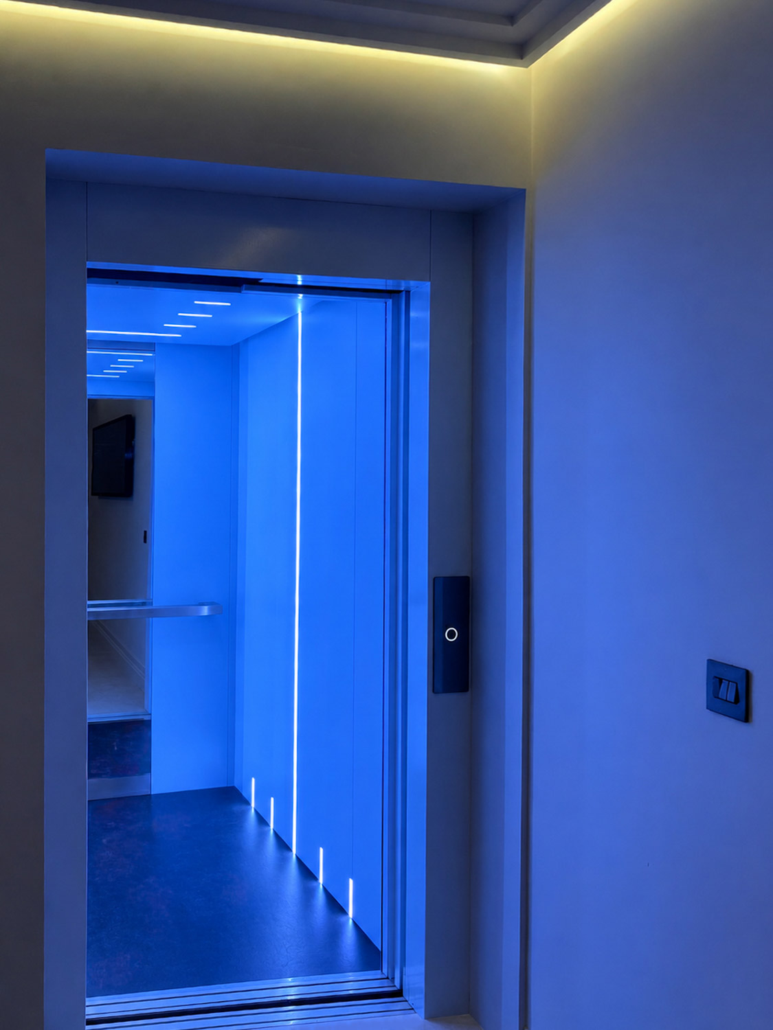 Eco+ home lift in a private Cork residence, featuring colour-responsive blue LED lighting and a sleek black landing operating panel.