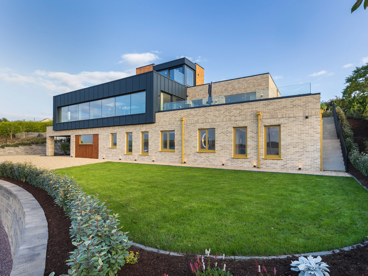 Modern private residence in Cork featuring an Eco+ three-stop home lift, with contemporary brick, timber and dark metal finishes.