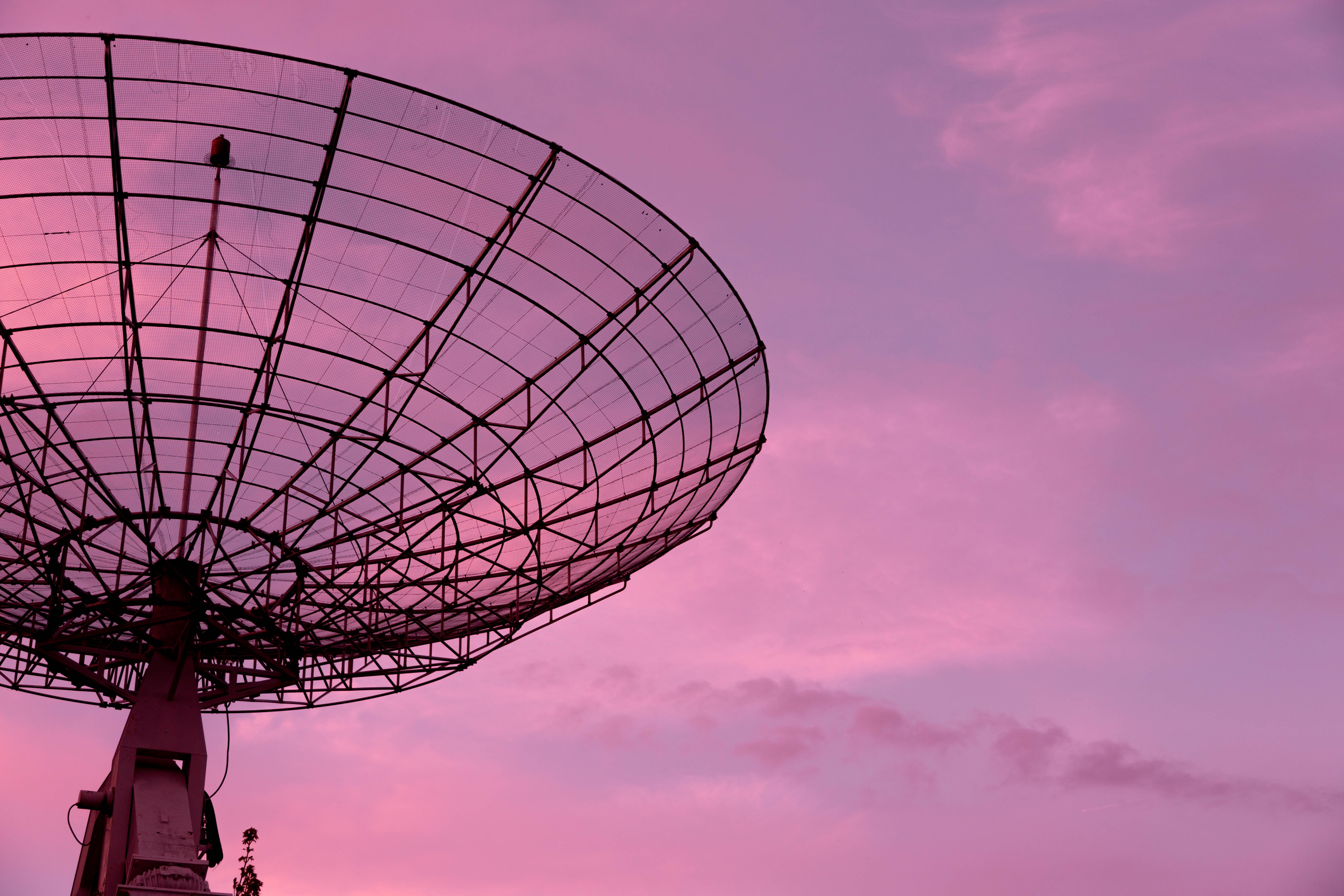 Picture of a big satellite with a nice pink sky as a background