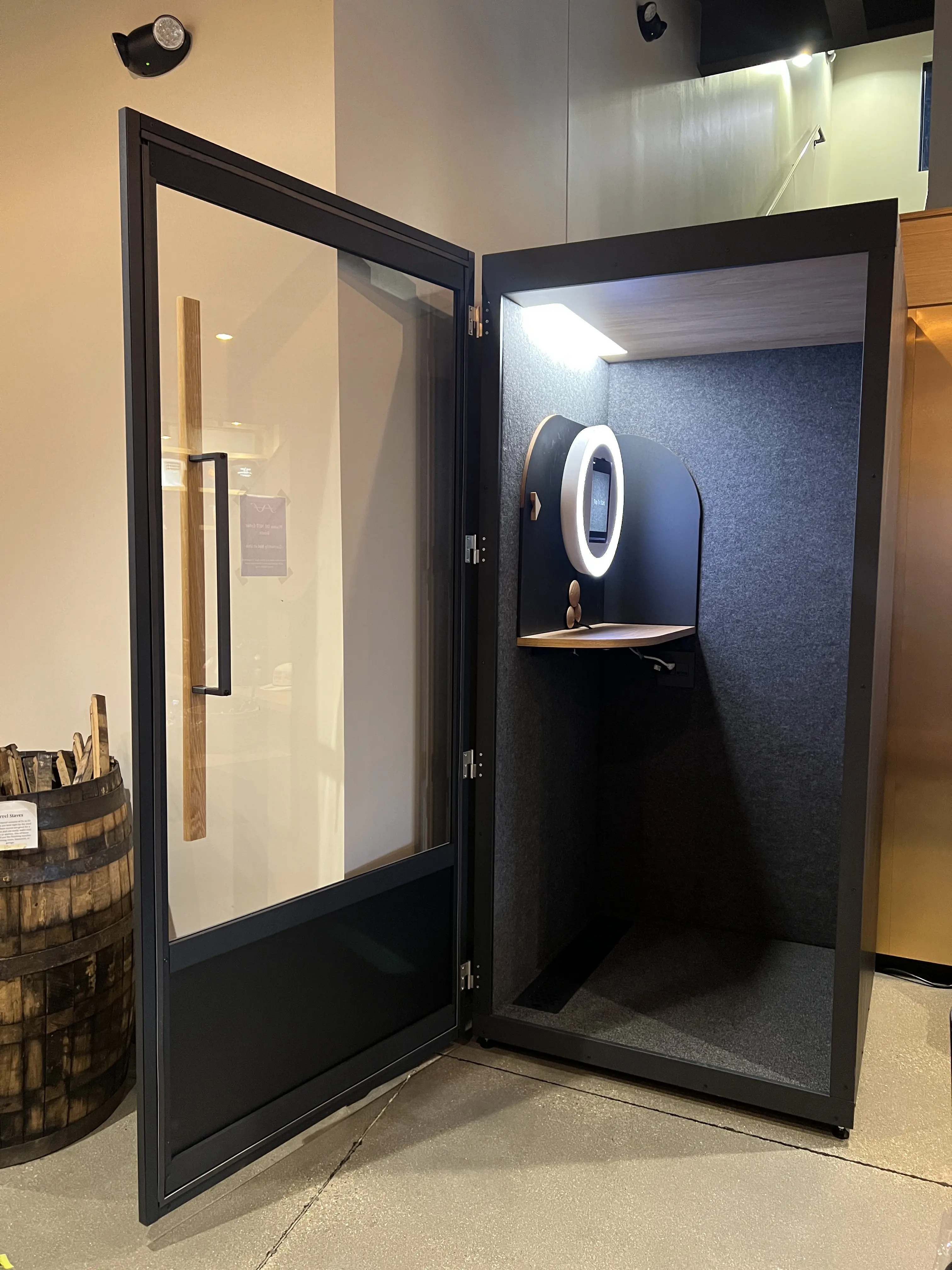 Custom branded testimonial video booth enclosure installed at a conference