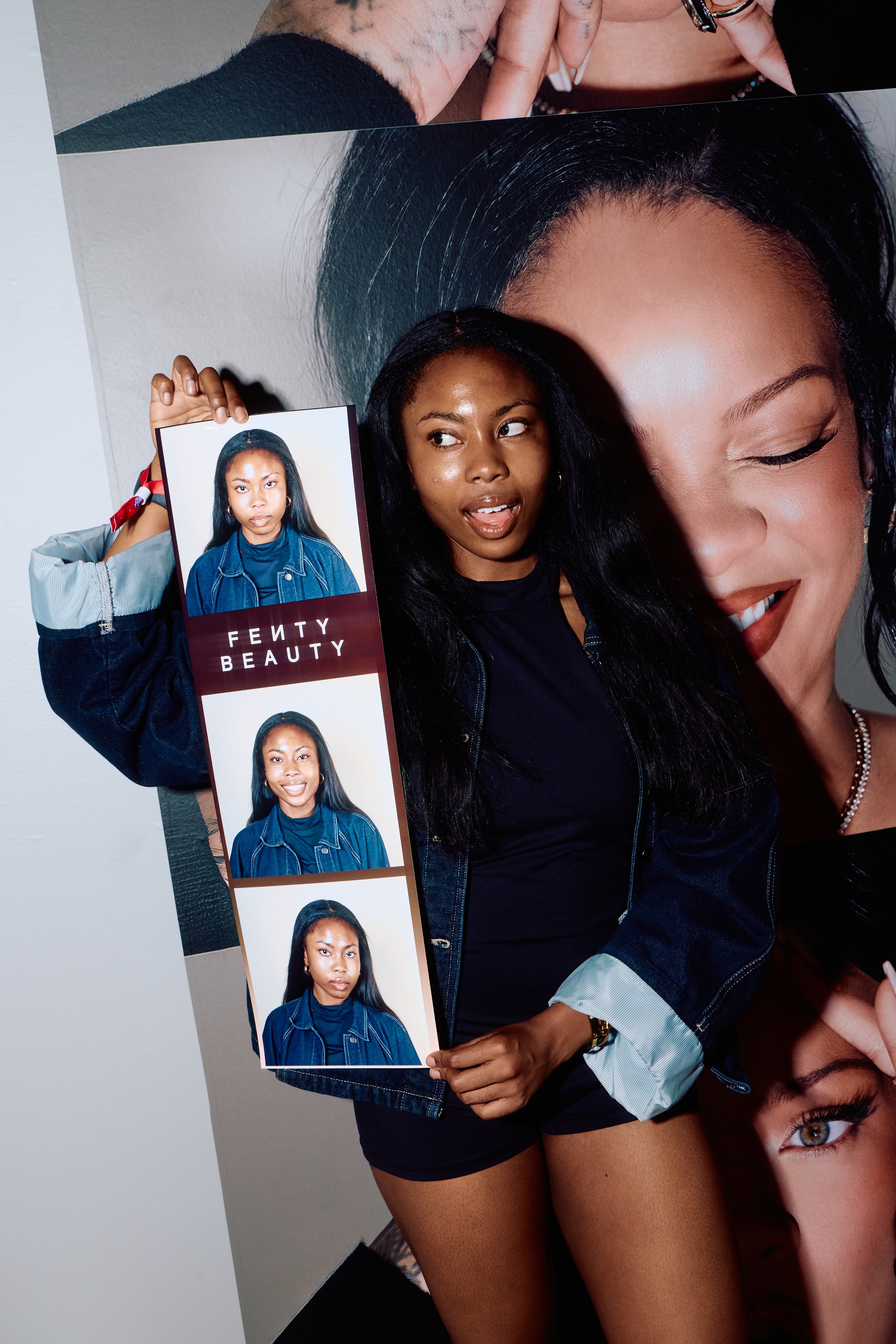Guest holding an oversized custom branded photo booth strip at a Fenty Beauty experiential marketing activation