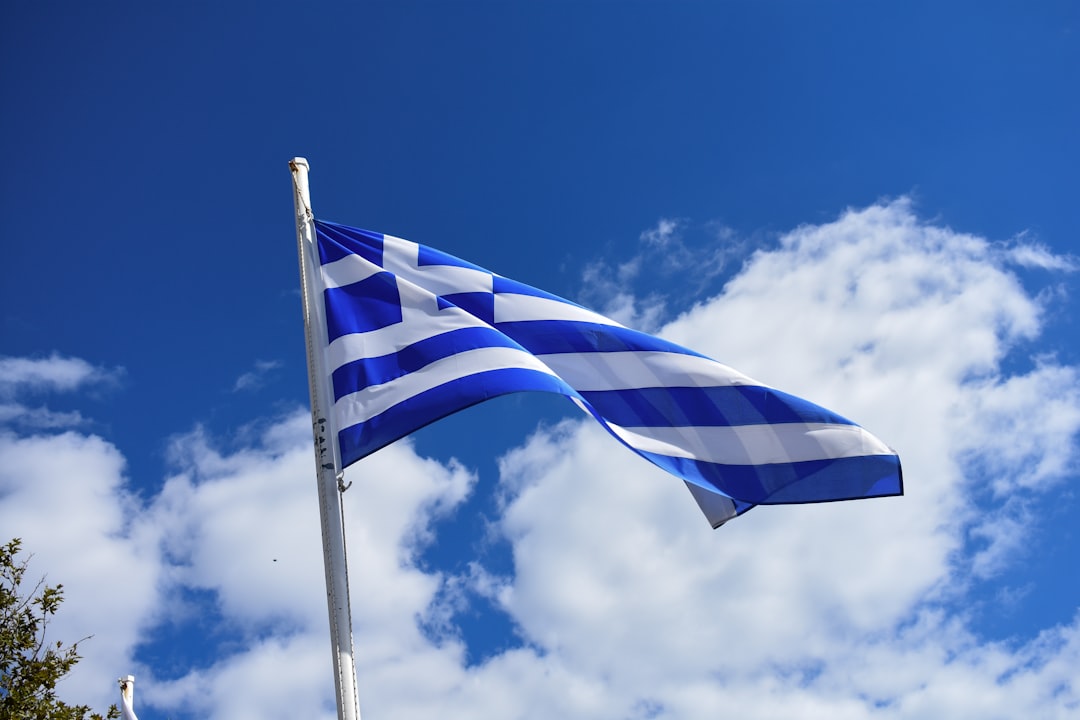 Greek flag waving against a blue sky