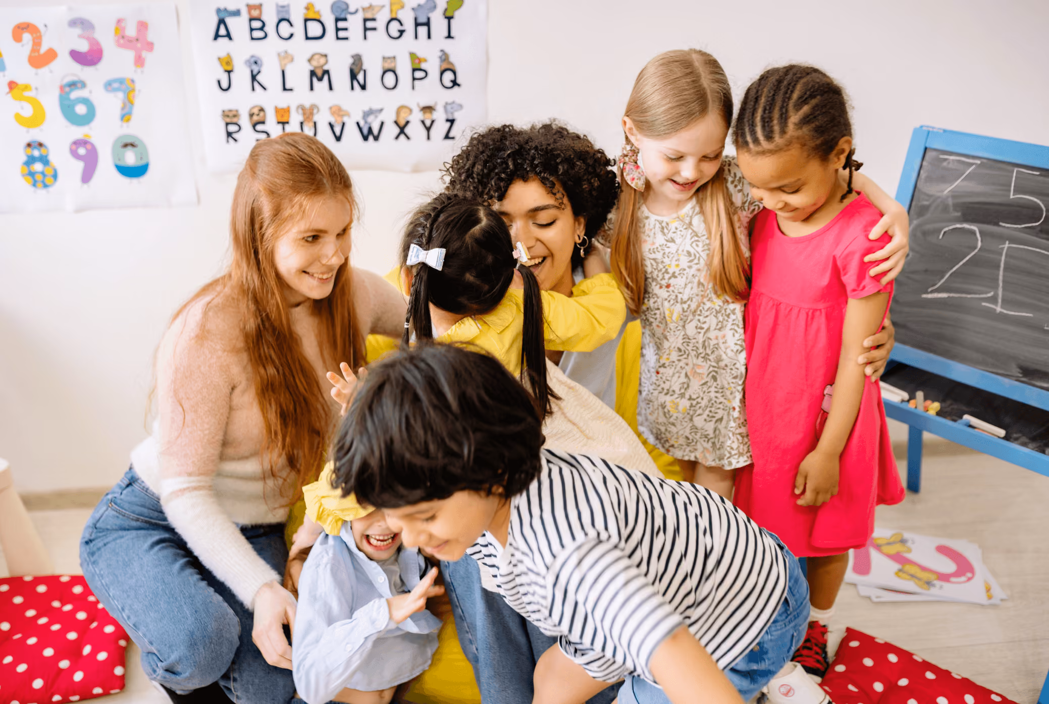 two teachers play with children