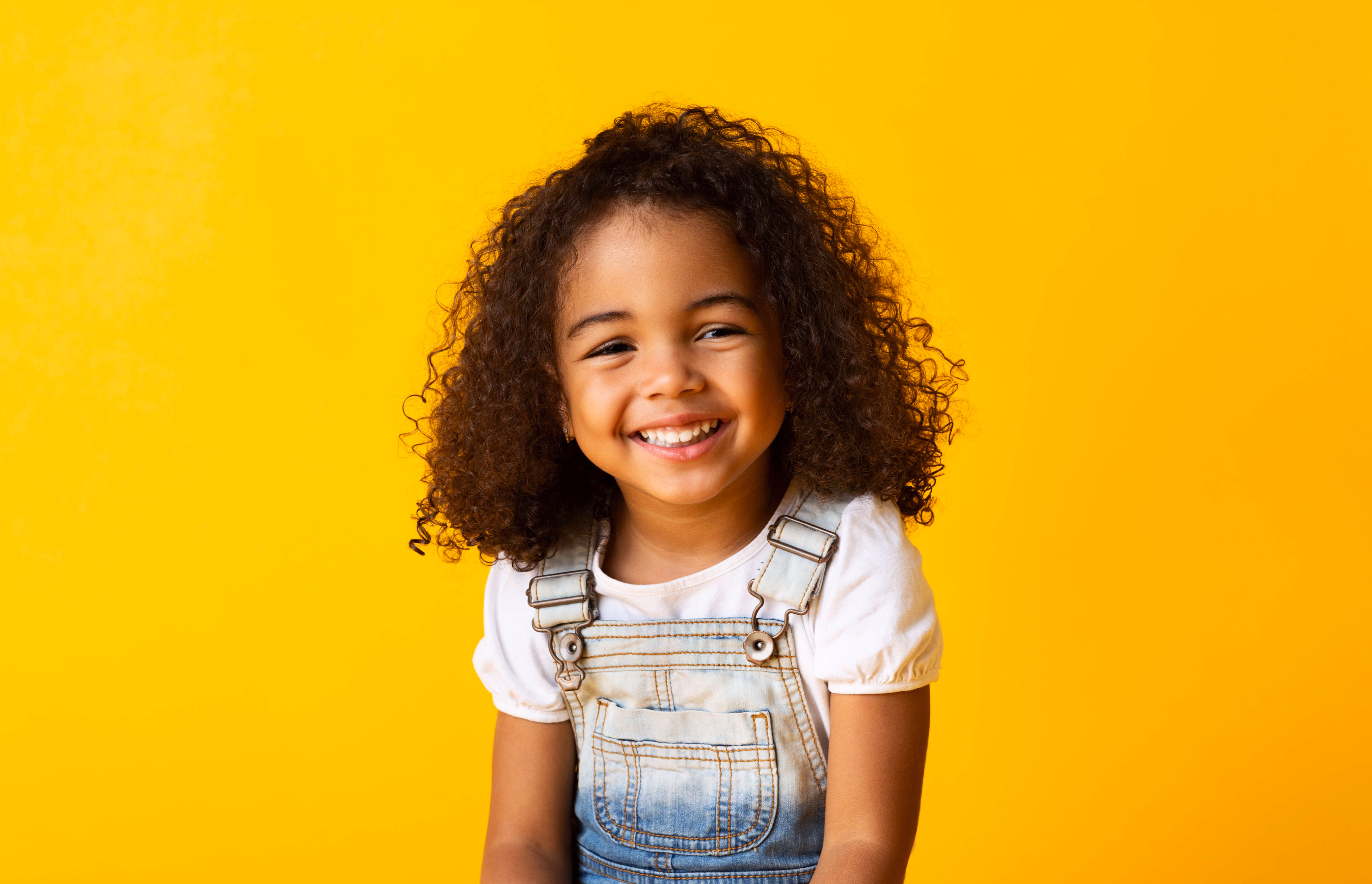Little girl on orange background