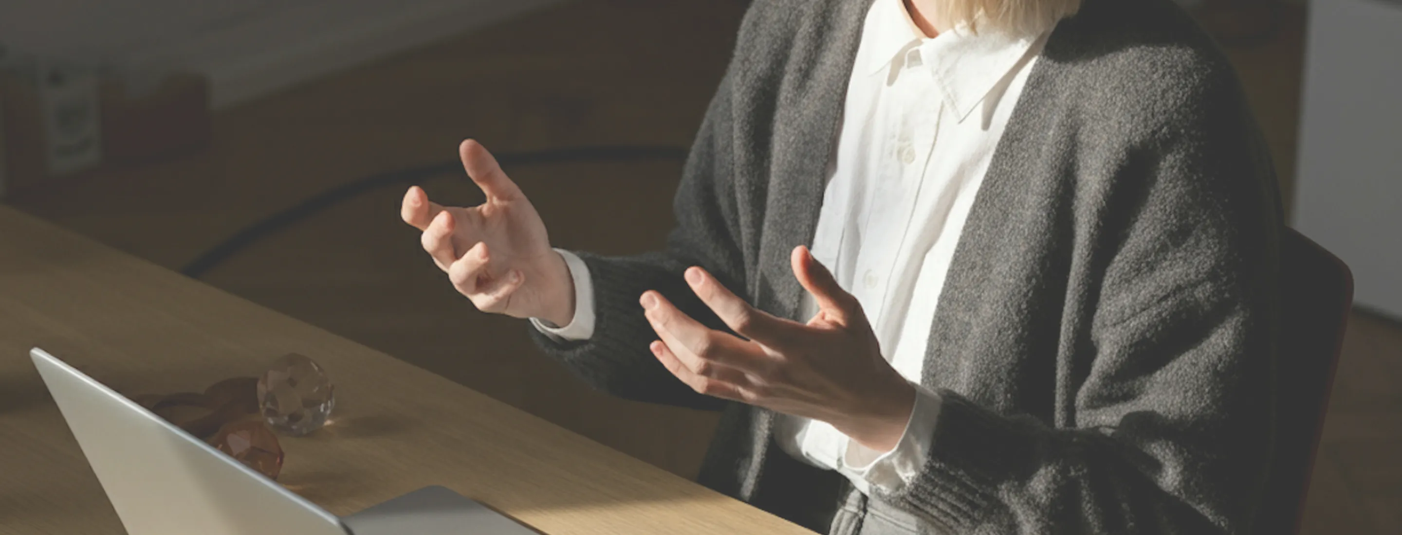 A woman standing in front of a laptop computer.