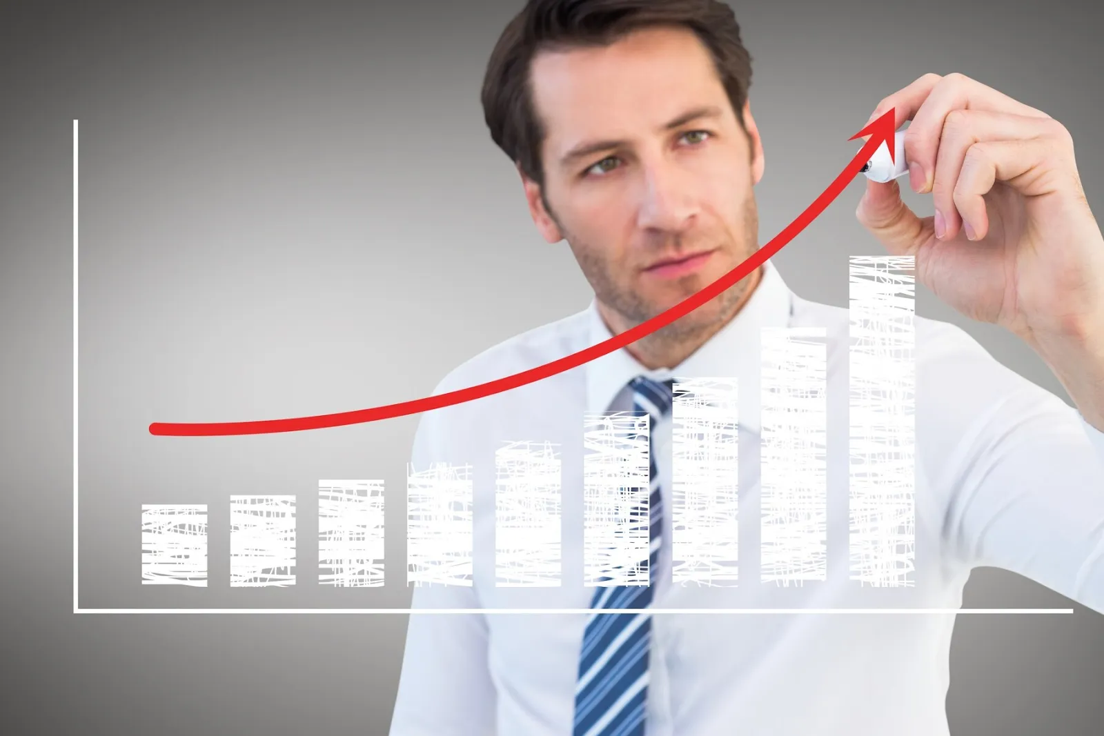 A man drawing an upward arrow in a bar chart 