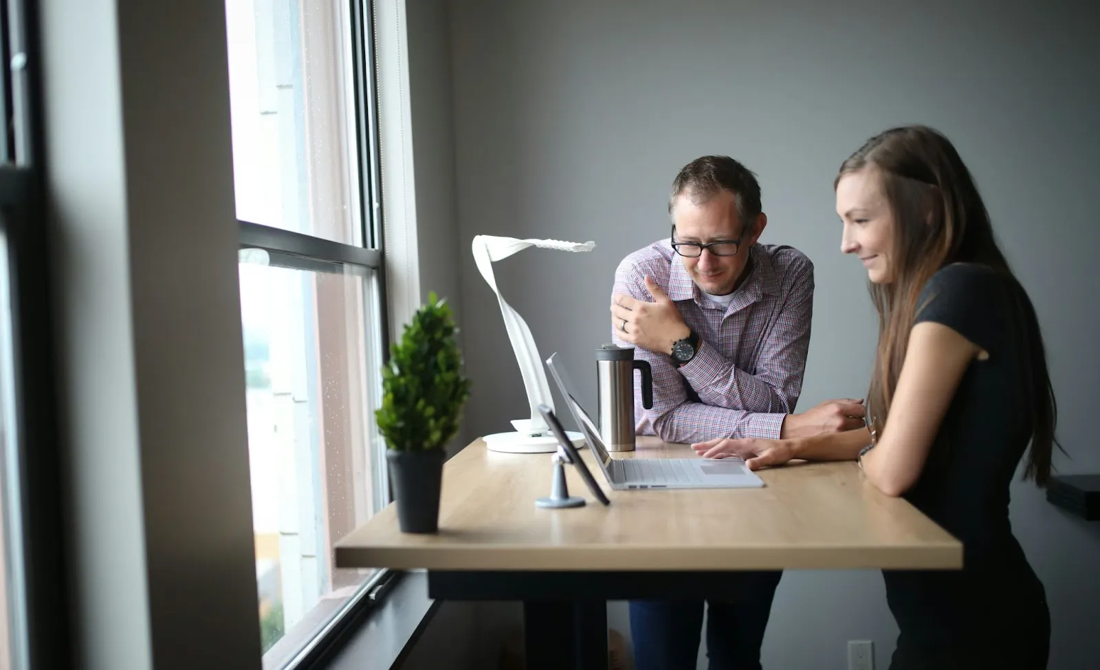 Two people stood at a standing desk