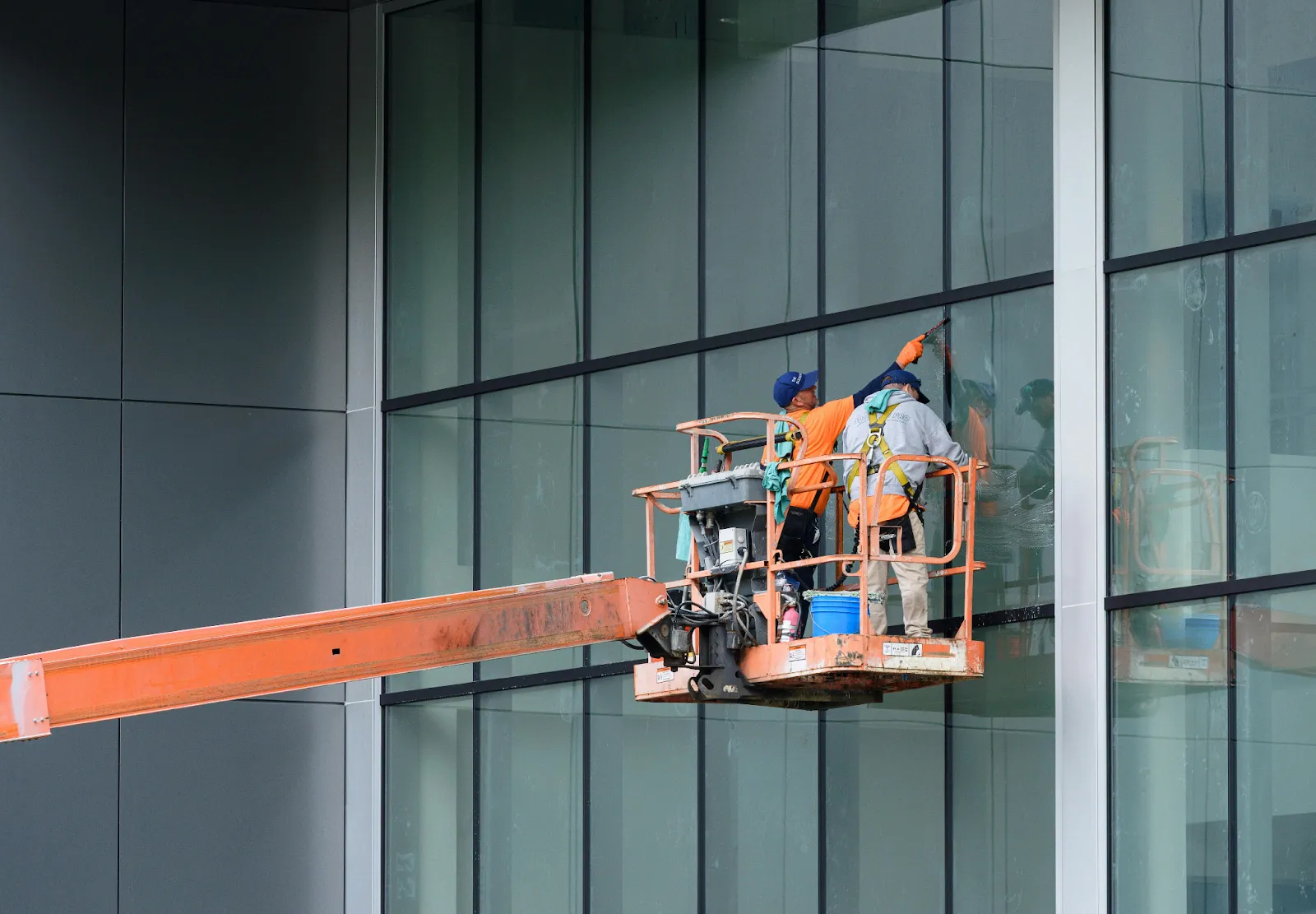 Photo of two people cleaning windows
