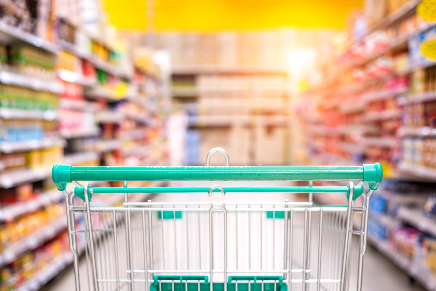 Green shopping trolley in supermarket