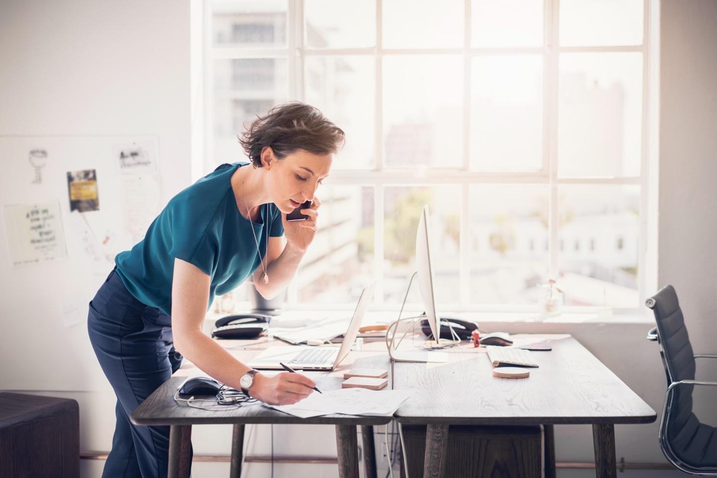 Woman on phone at office desk
