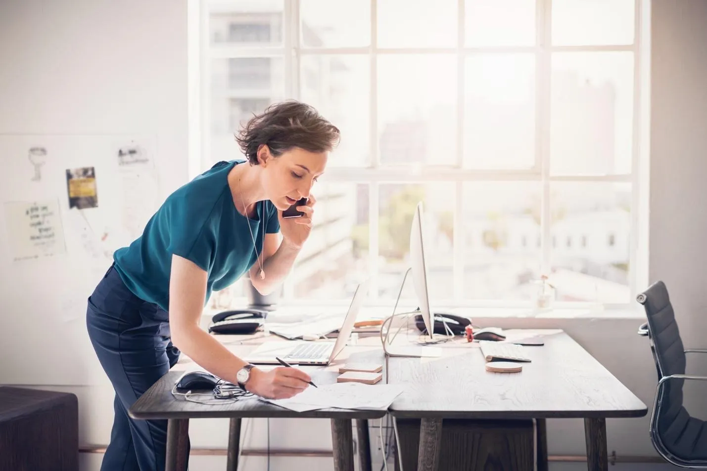 Woman on phone at office desk