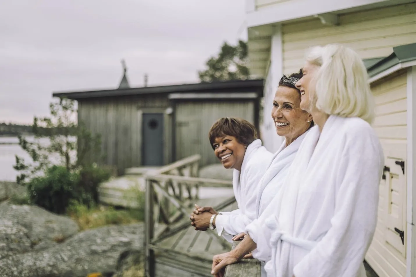 Smiling women in robes on patio
