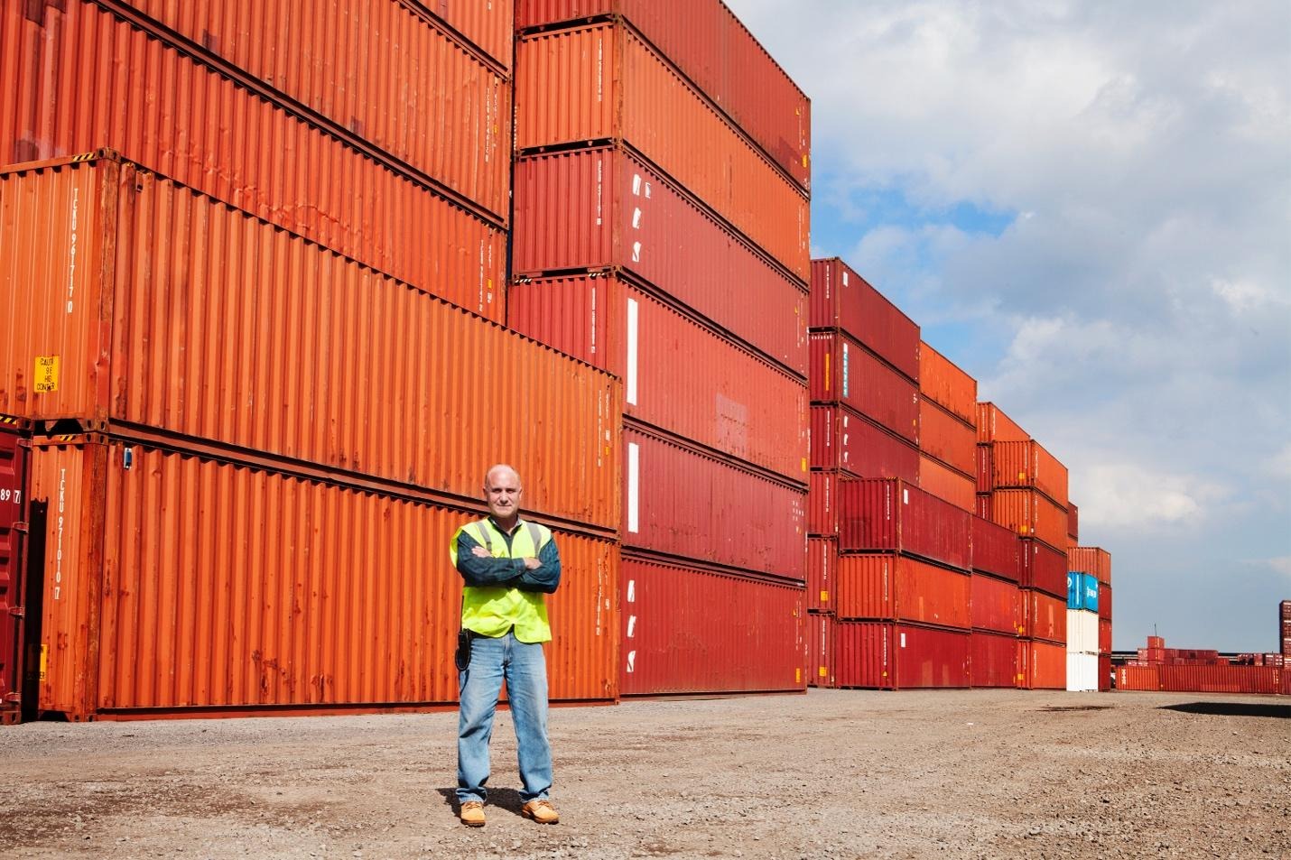 Man in front of storage crates