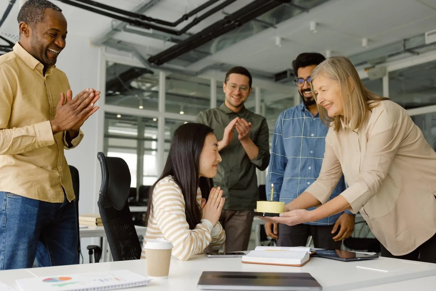 People with birthday cake in office