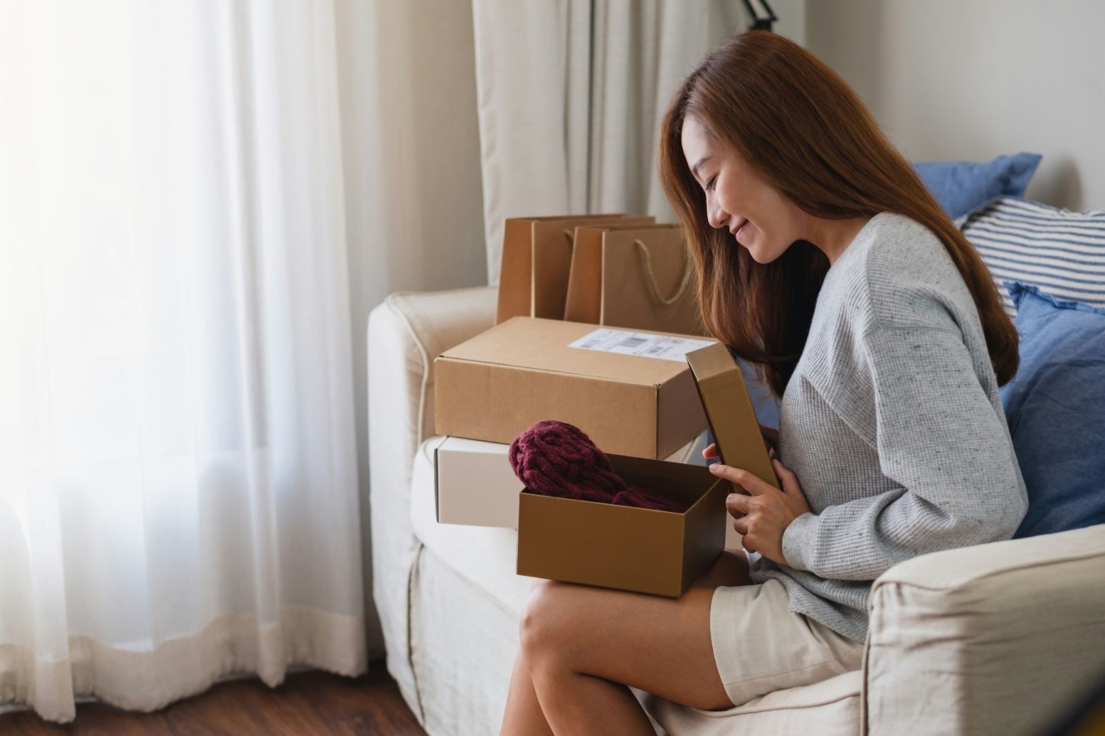 A women opening a gift in the post