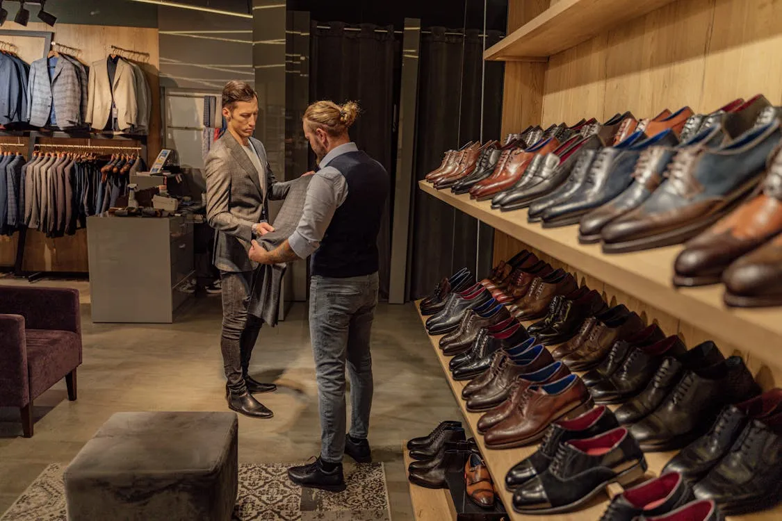 Men looking at a pair of trousers