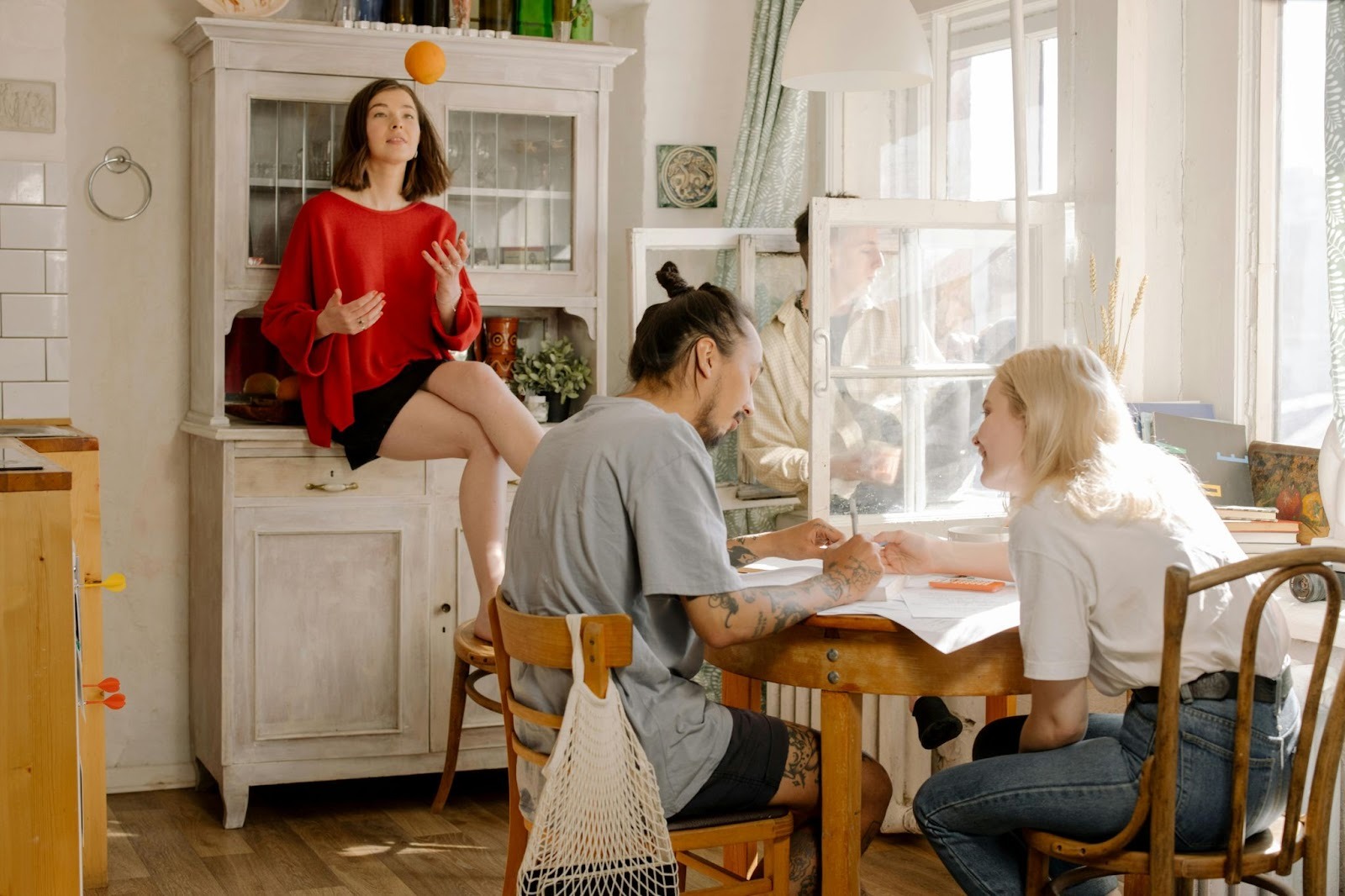 Women in red and two people sat at a table