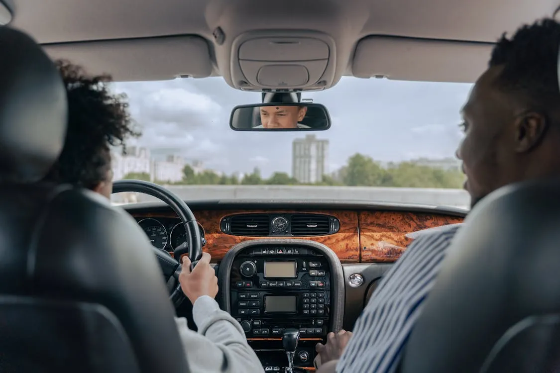 Man and young person in a car