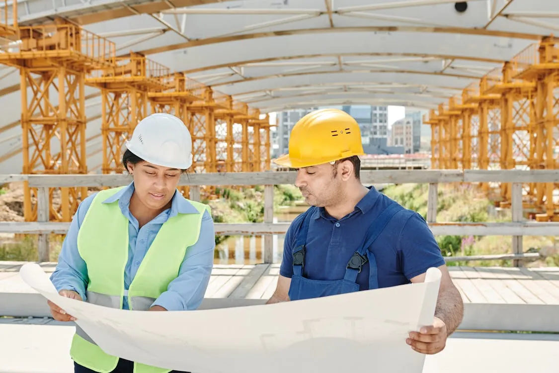 A women and man holding a blueprint