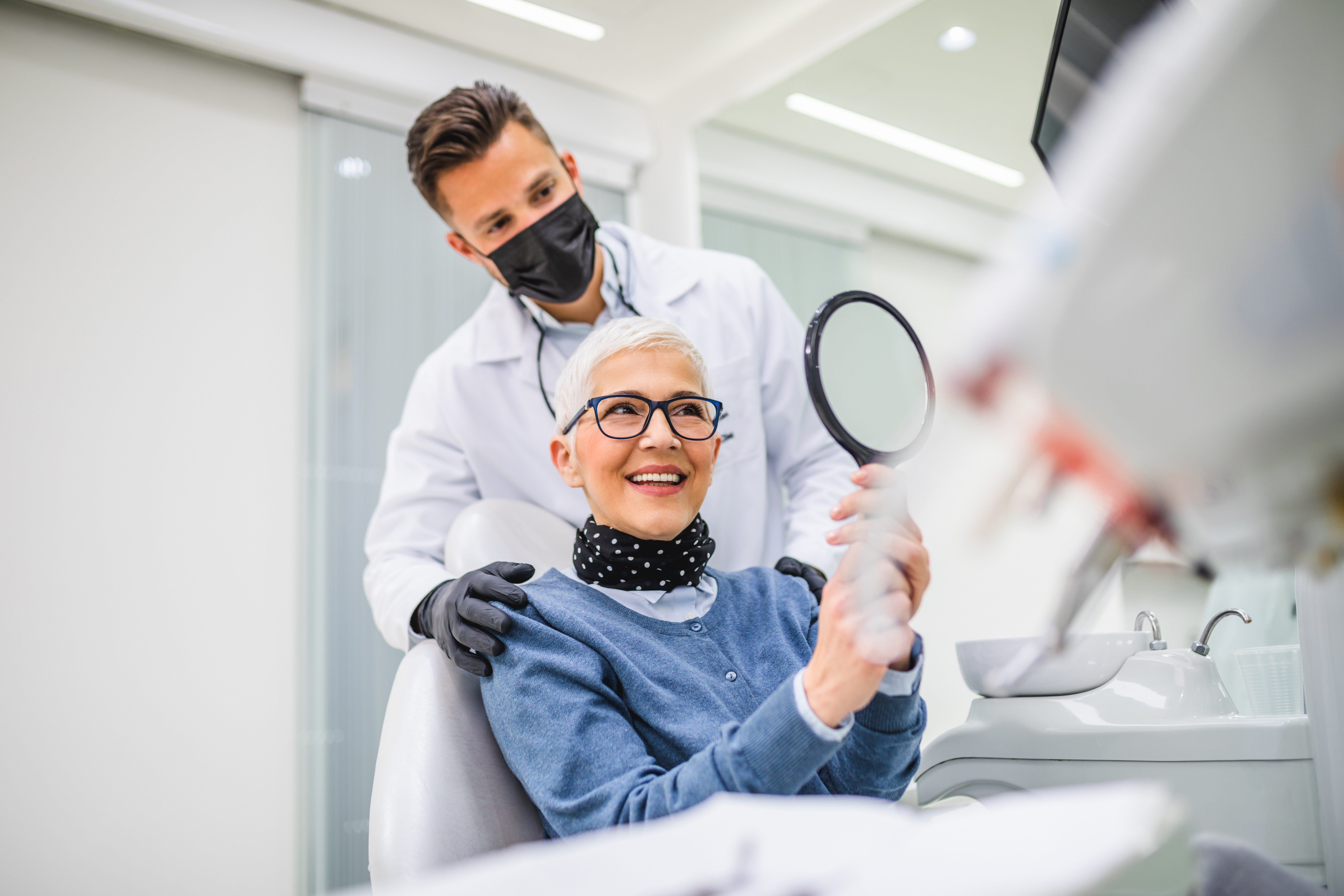 Women sat in dental chair smiling