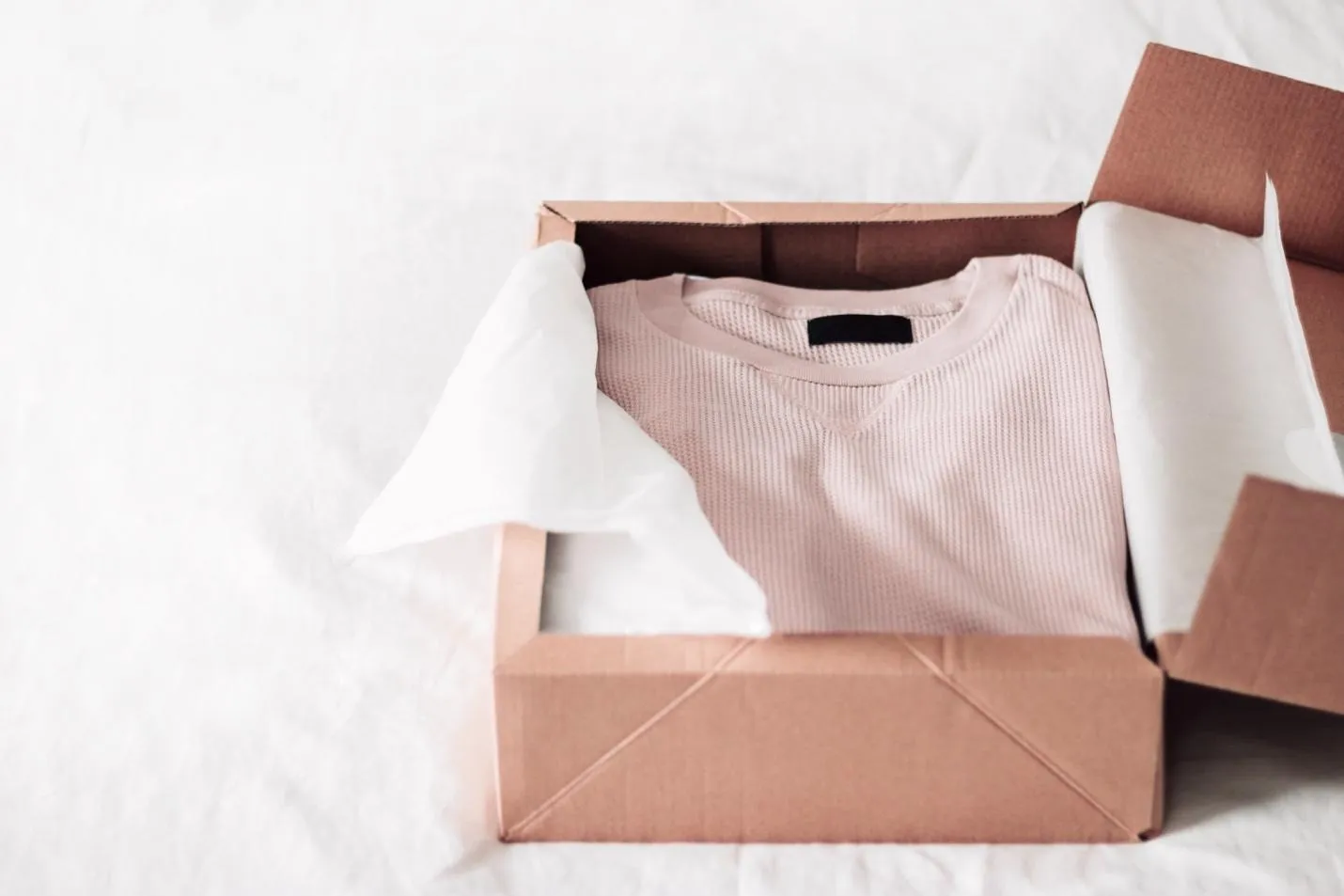 Opened package with a pink shirt in it