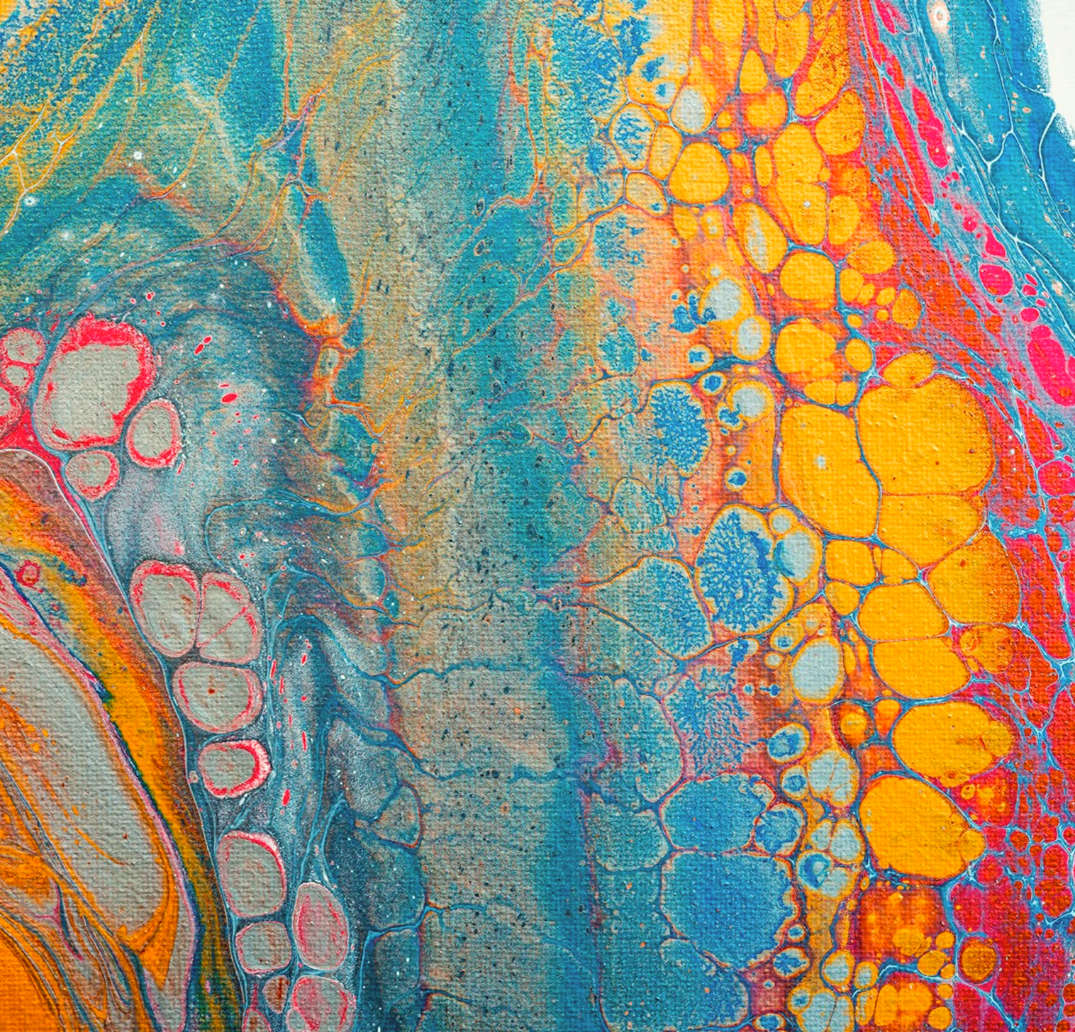 Close-up of vibrant fluid abstract painting with blue, yellow, orange, and red cells and textured patterns.