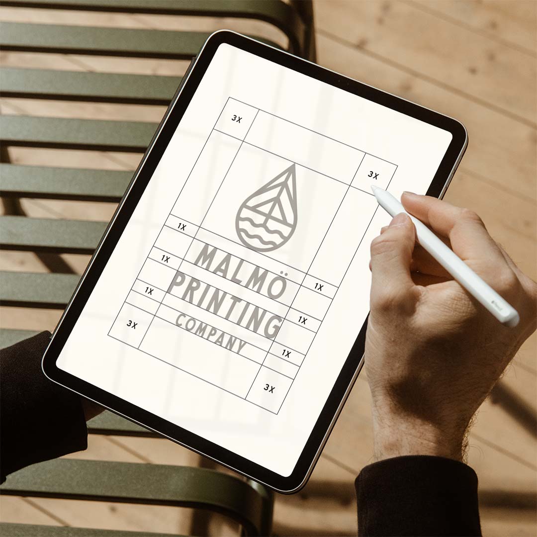 Person designing a custom logo on an iPad pro.