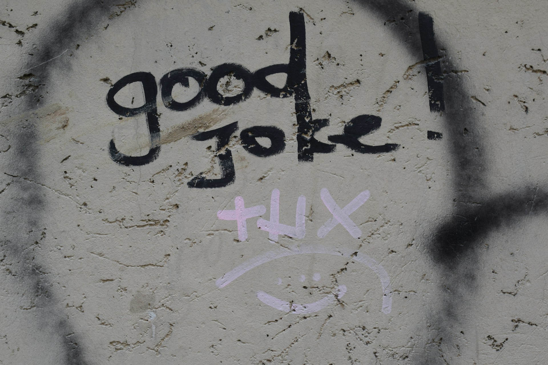 A concrete wall with graffiti reading "good joke." "thx"