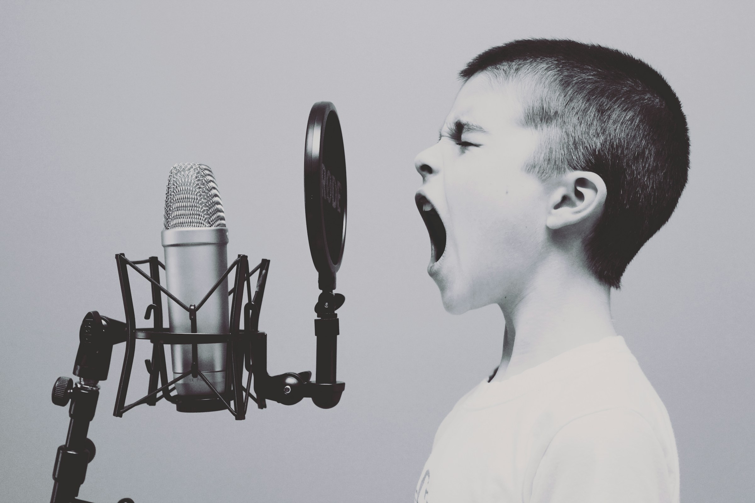 A child yells into a microphone.